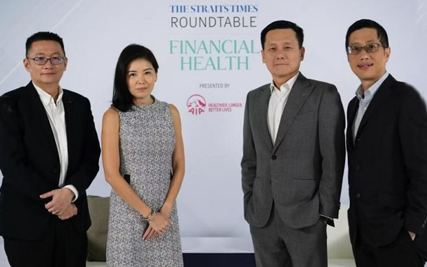  ​(From left) Mr Tan Ooi Boon, moderator and ST Invest editor; Ms Melita Teo, chief customer and digital officer at AIA Singapore; Associate Professor Tan Hiang Khoon, deputy chief executive of Singapore General Hospital; and Mr Herbert Ho, a biotech professional. ST PHOTO NG SOR LUAN 