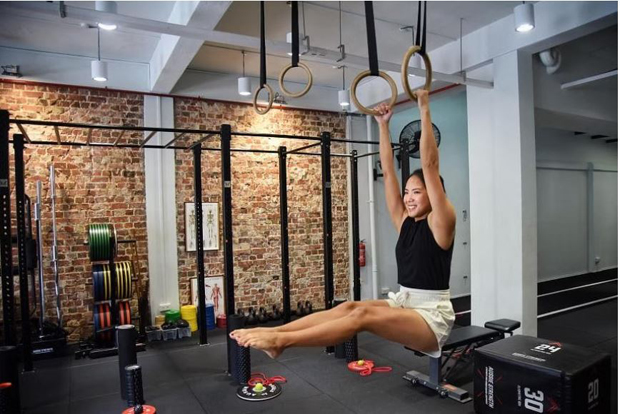  ​Project manager Jingxi Lim, 30, seen here exercising at private gym Tribody Fitness, says she prefers to work out in the mornings before she starts her day. ST PHOTO HENG YI-HSIN 