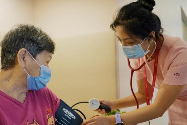 A member of HCA Hospice Care's home palliative care team visiting a patient at her home. PHOTO HCA HOSPICE CARE