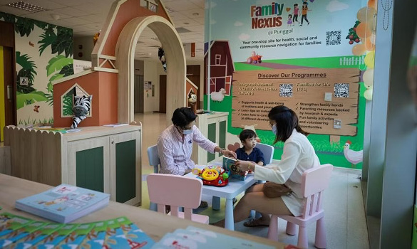  ​​Mr Amparo Juan Carlos Camero (left), his wife Jasmine Tan and their son at the Family Nexus@Punggol located at Punggol Polyclinics, on Jan 22 ST PHOTO GIN TAY 