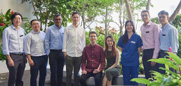  ​Mr Lim Wen Ming (seated) and Mr Lim Wen Cong (4th from left) with some members of their liver transplant team, including Professor Brian Goh, Associate Professor Prema Raj (2nd and 3rd from left) and Dr Thinesh Lee Krishnamoorthy (2nd from right).