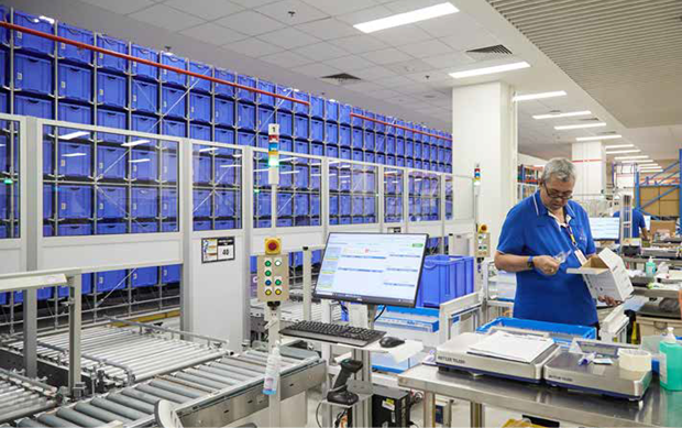  ​The system automatically fills orders by picking items from the shelves (below), conveys them to the packing station (above) for checking and packing for delivery to the wards and SGH departments. 